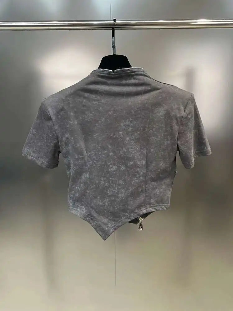 Asymmetrical zip crop top in stonewashed gray with sculpted hem and edgy diagonal zipper, showcasing the back design.