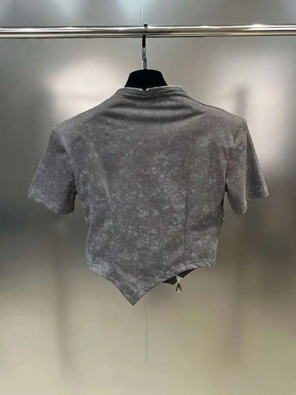 Asymmetrical zip crop top in stonewashed gray with sculpted hem and edgy diagonal zipper, showcasing the back design.