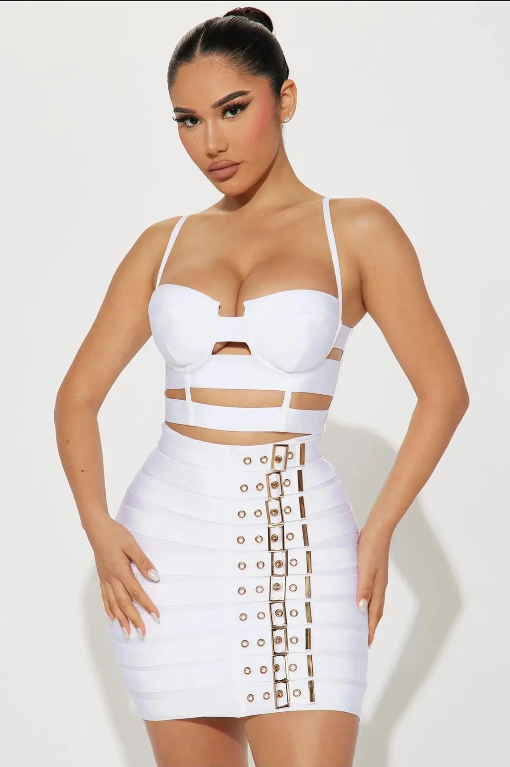 Sculpted buckled bandage two piece set on model, showcasing figure-defining design and high-impact glamour.
