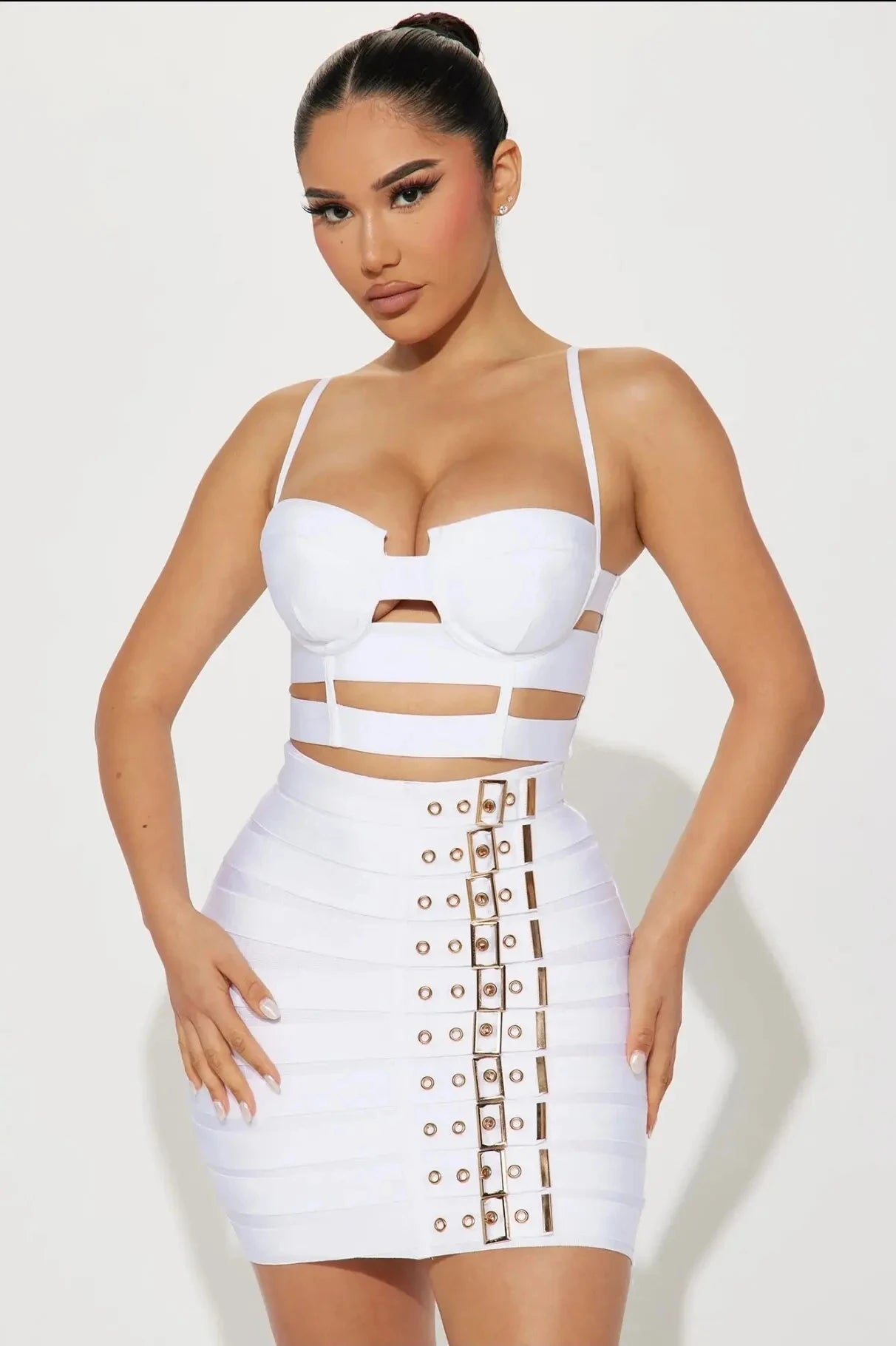 Sculpted buckled bandage two piece set on model, showcasing figure-defining design and high-impact glamour.