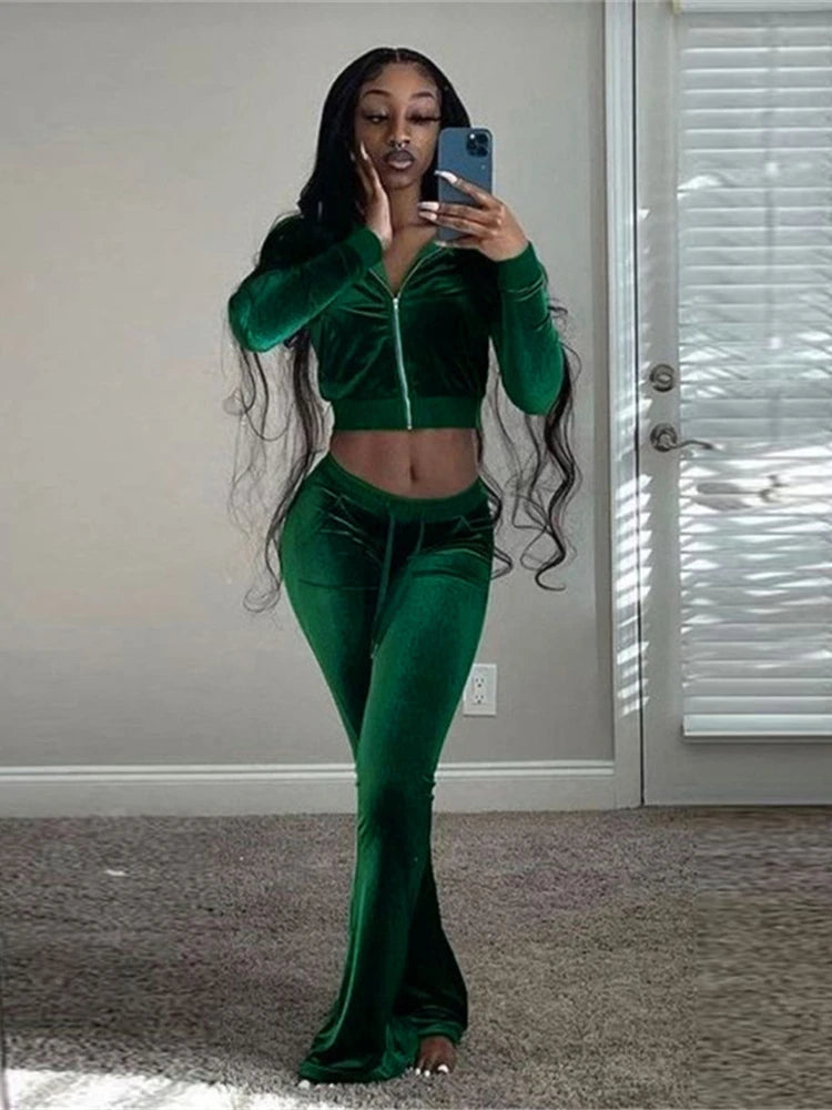 Model showcasing the Velour Luxe Zip-Up Jogger Set in green, featuring a zip-front jacket and mid-waist joggers.