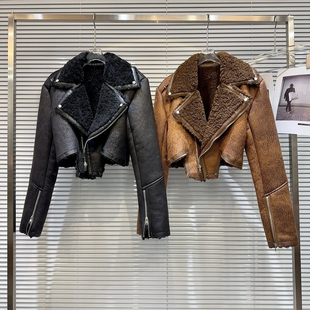 Cropped faux-leather shearling moto jacket in black and brown displayed on hangers, showcasing winter style and bold designs.
