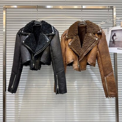 Cropped faux-leather shearling moto jacket in black and brown displayed on hangers, showcasing winter style and bold designs.