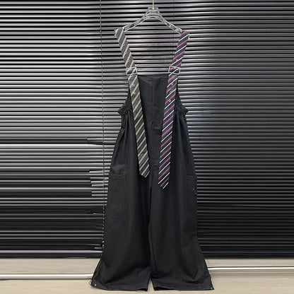 Alt Tag: Executive Street Suspender Jumpsuit black wide-leg high-waist jumpsuit with detachable tie-style suspenders on hanger
