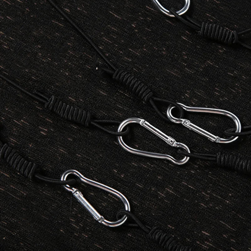 Close-up of silver-tone hardware details on the Black Safety-Pin Asymmetrical Bodycon Mini Dress.