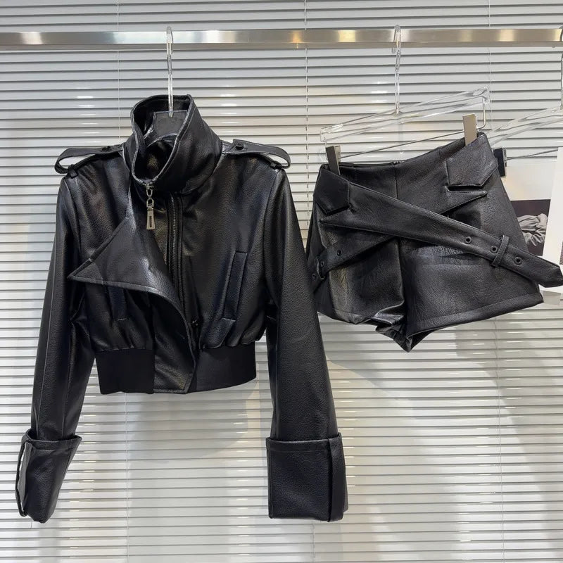 faux leather mini set with jacket and shorts displayed on hangers against a lined background.