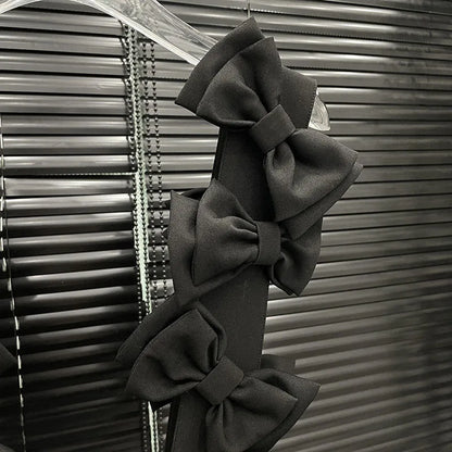 Close-up of layered 3D bows on the Bow Cascade Statement Crop Top showcasing the dramatic black design.