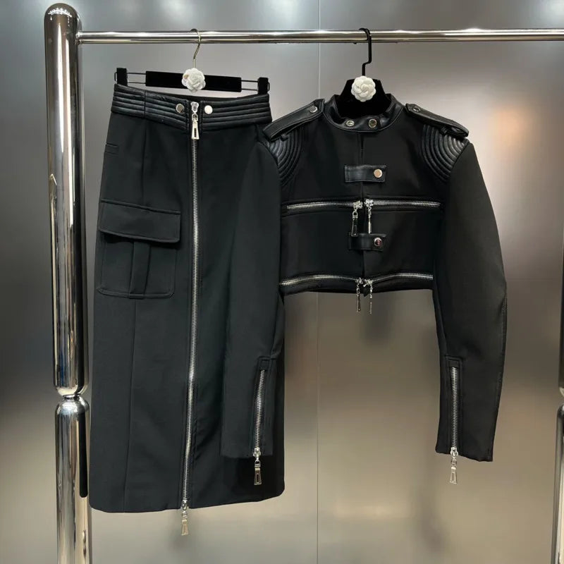 Structured moto jacket cargo skirt set displayed on hangers against a metallic backdrop, showcasing edgy streetwear style.