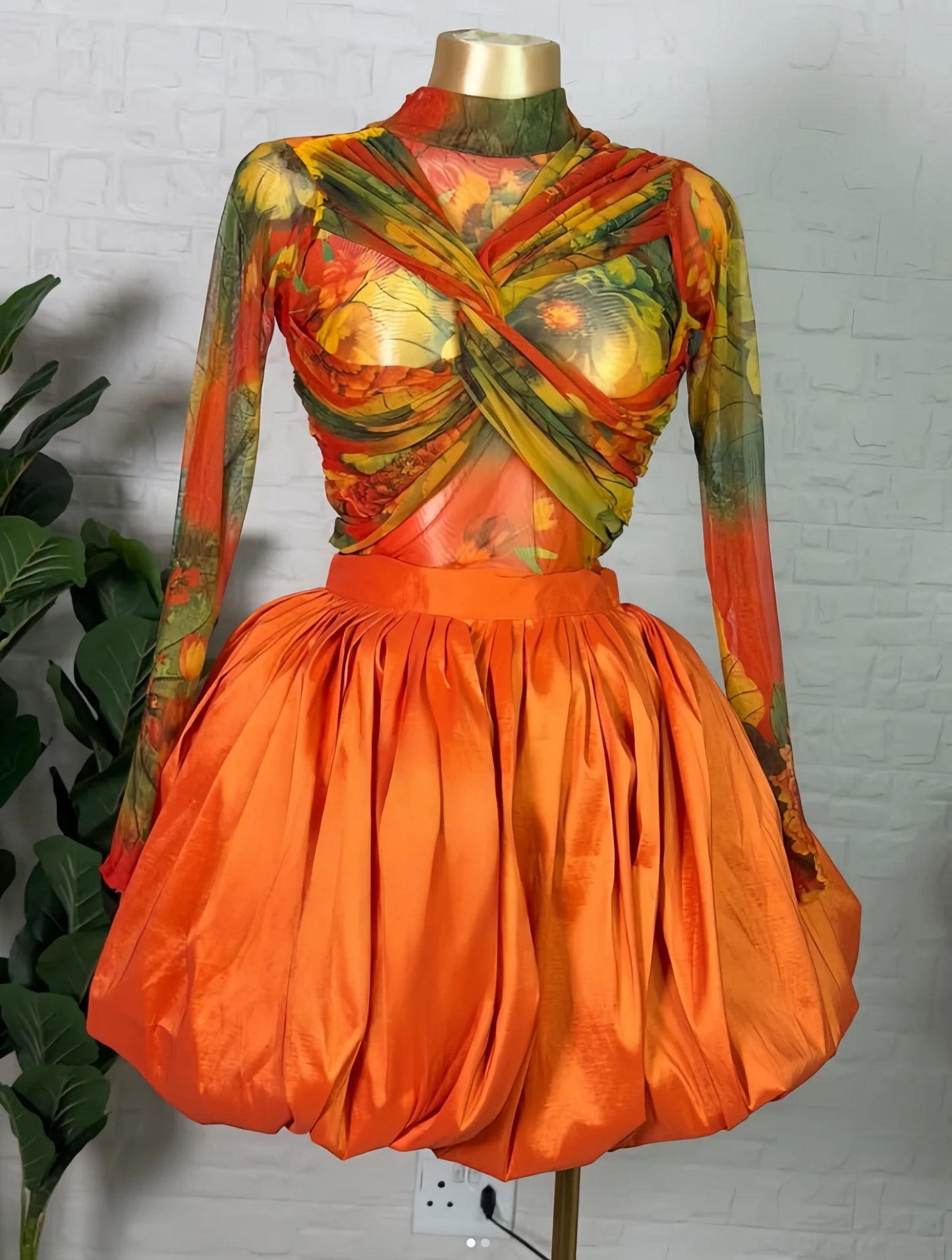 Floral crop top and bubble mini skirt set featuring a twist-front design and vibrant colors.