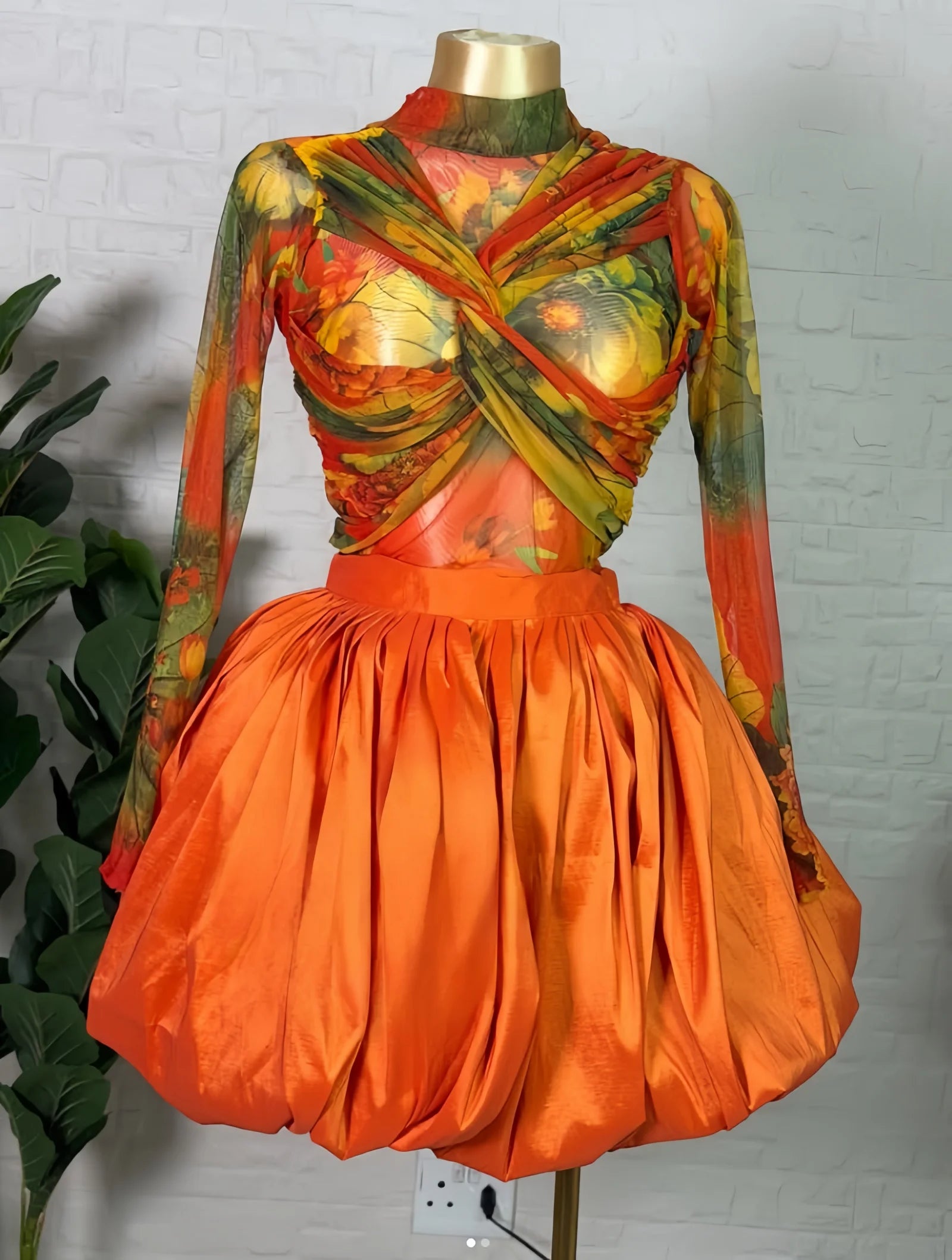 Floral crop top and bubble mini skirt set featuring a twist-front design and vibrant colors.