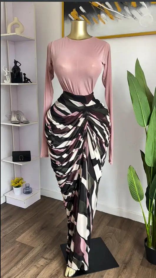 Sculpted Mirage Draped Maxi Dress featuring a fitted knit top and sculpted pleats in an abstract skirt.