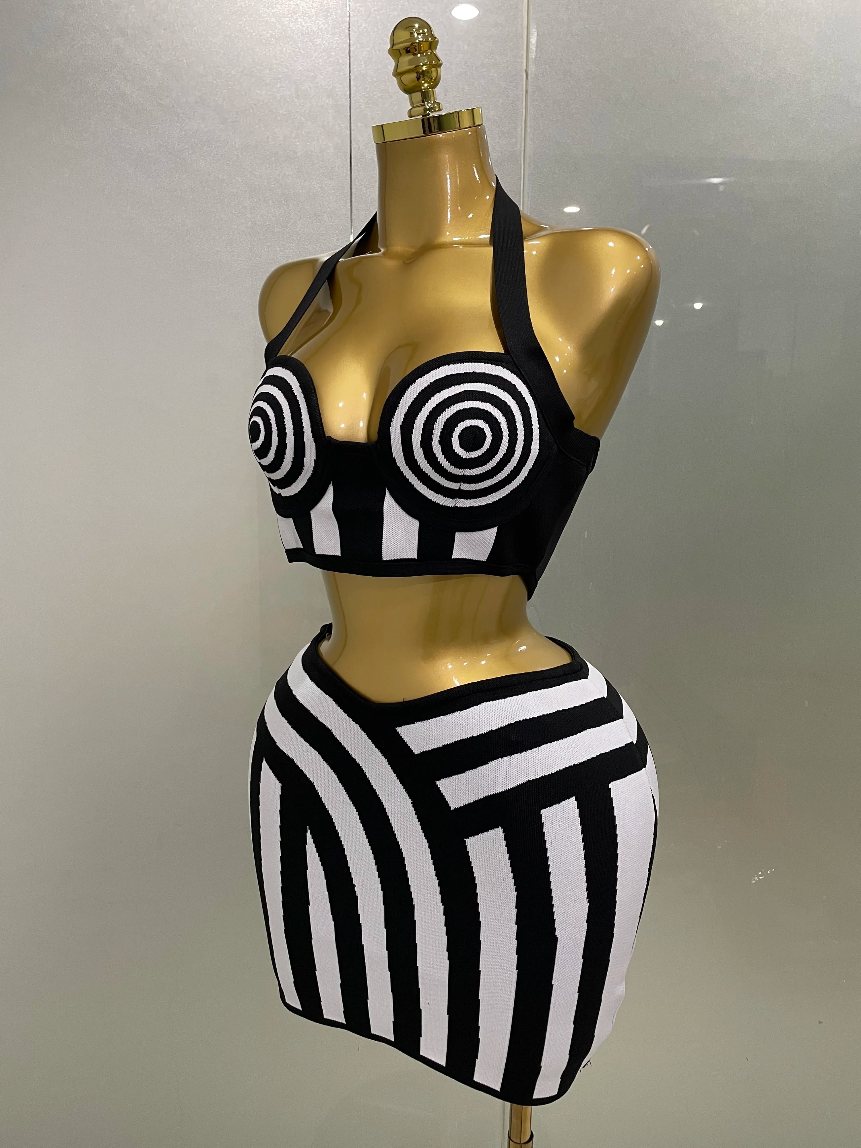 Optical illusion bandage set featuring a bold halter top and body-hugging skirt in black and white.