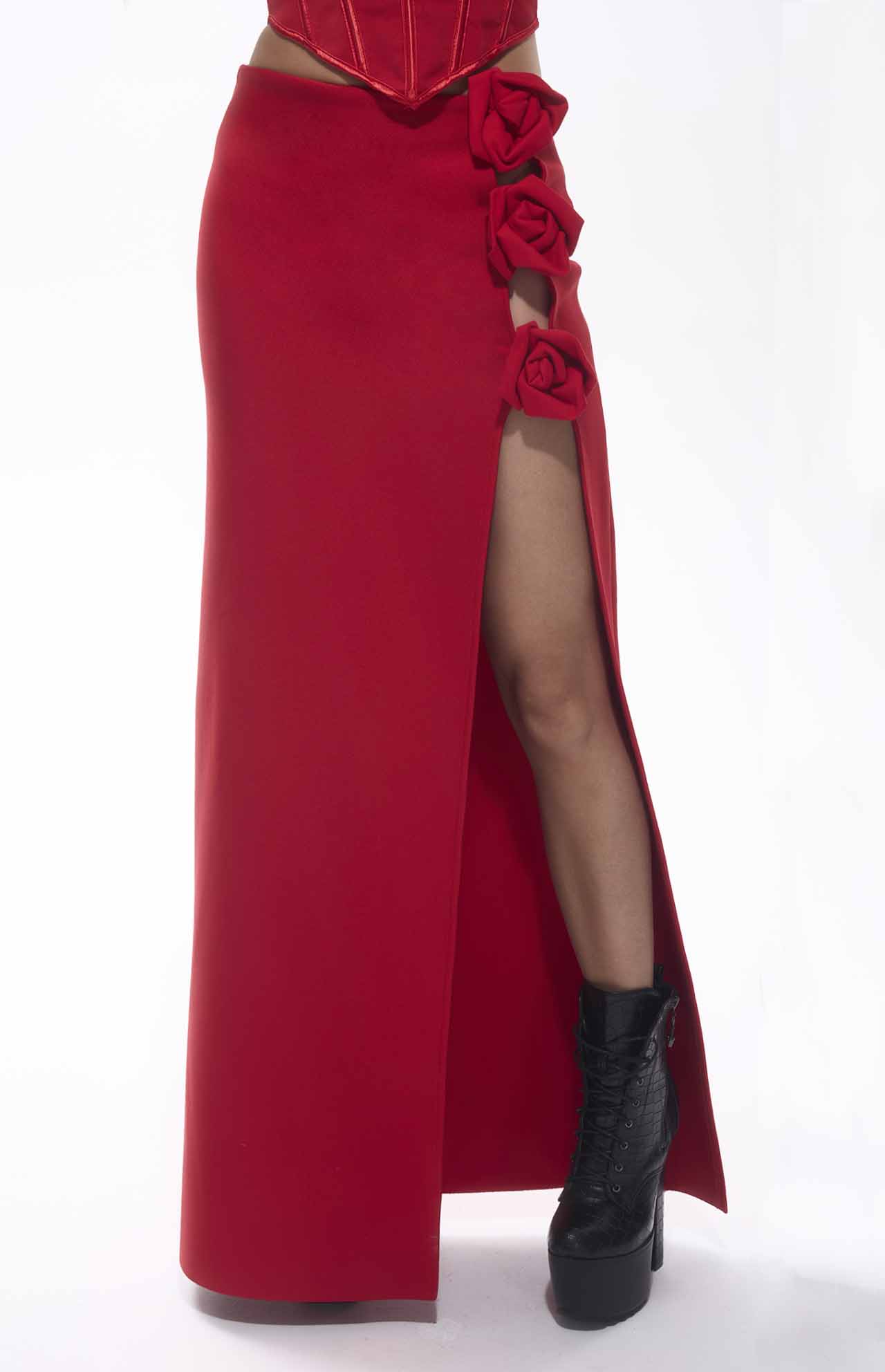 Bold red bandage flower maxi skirt with high slit and floral accents, perfect for chic events.