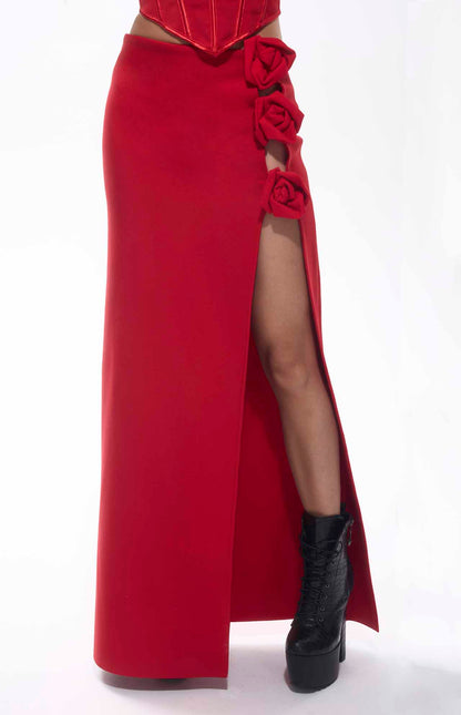 Bold red bandage flower maxi skirt with high slit and floral accents, perfect for chic events.