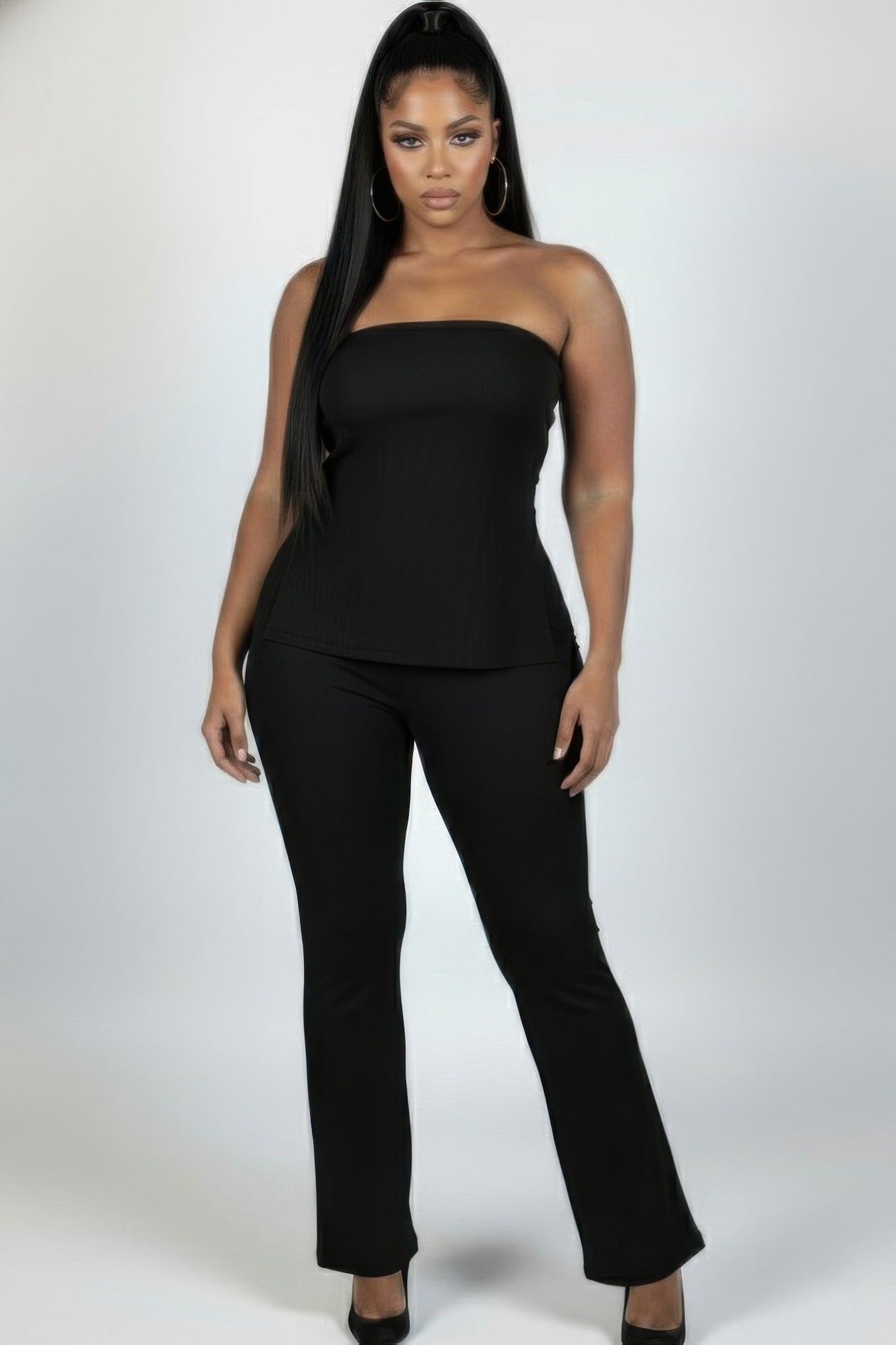 Plus size ribbed tube top and flare pants set worn by a model, showcasing a stylish black ensemble with a slit tube top.