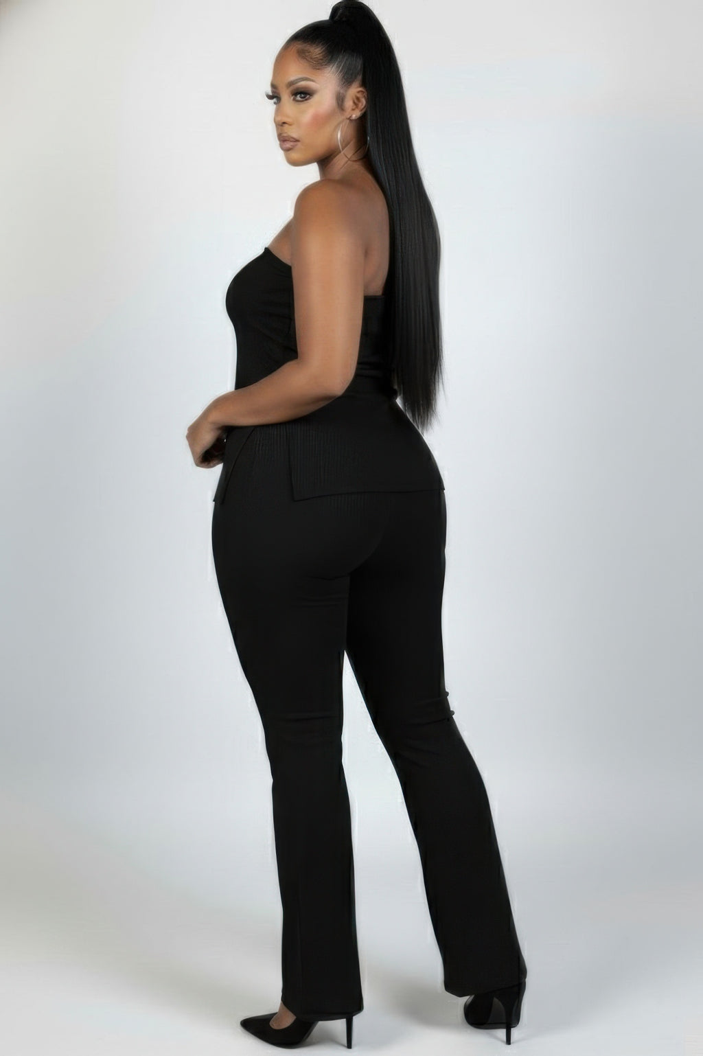 Plus size ribbed tube top and flare pants set model showcasing a sleek look from the back, highlighting stylish curves.
