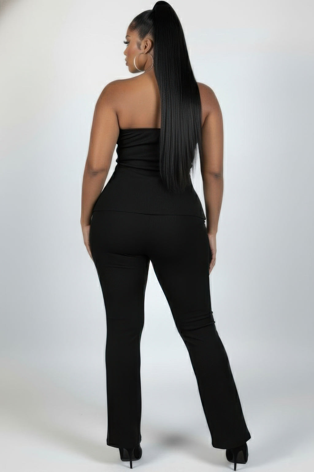 Plus size ribbed tube top and flare pants set showcasing a sleek design and confident style from the back.