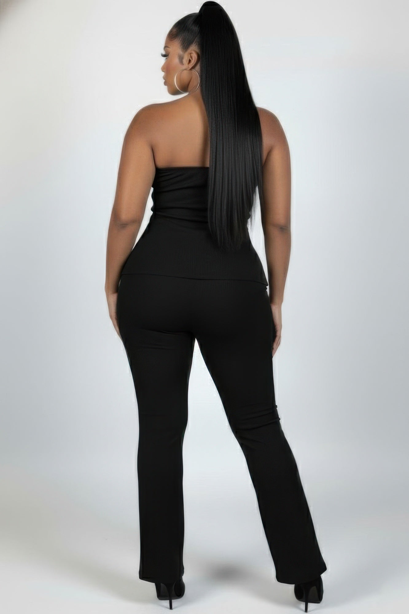 Plus size ribbed tube top and flare pants set showcasing a sleek design and confident style from the back.