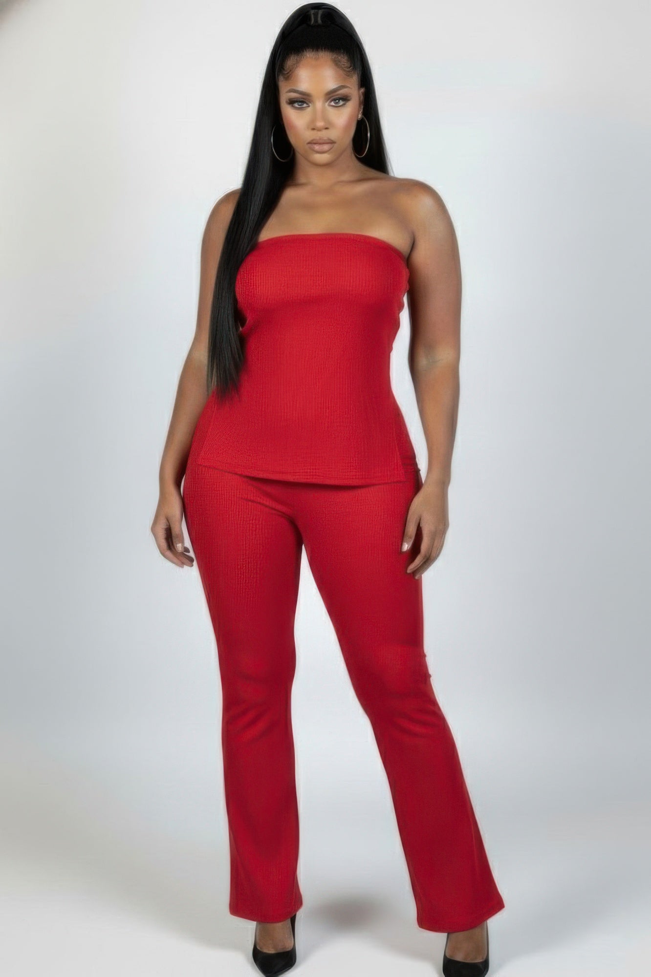 Plus size ribbed tube top and flare pants set in bold red, showcasing stylish side slit and flattering silhouette.