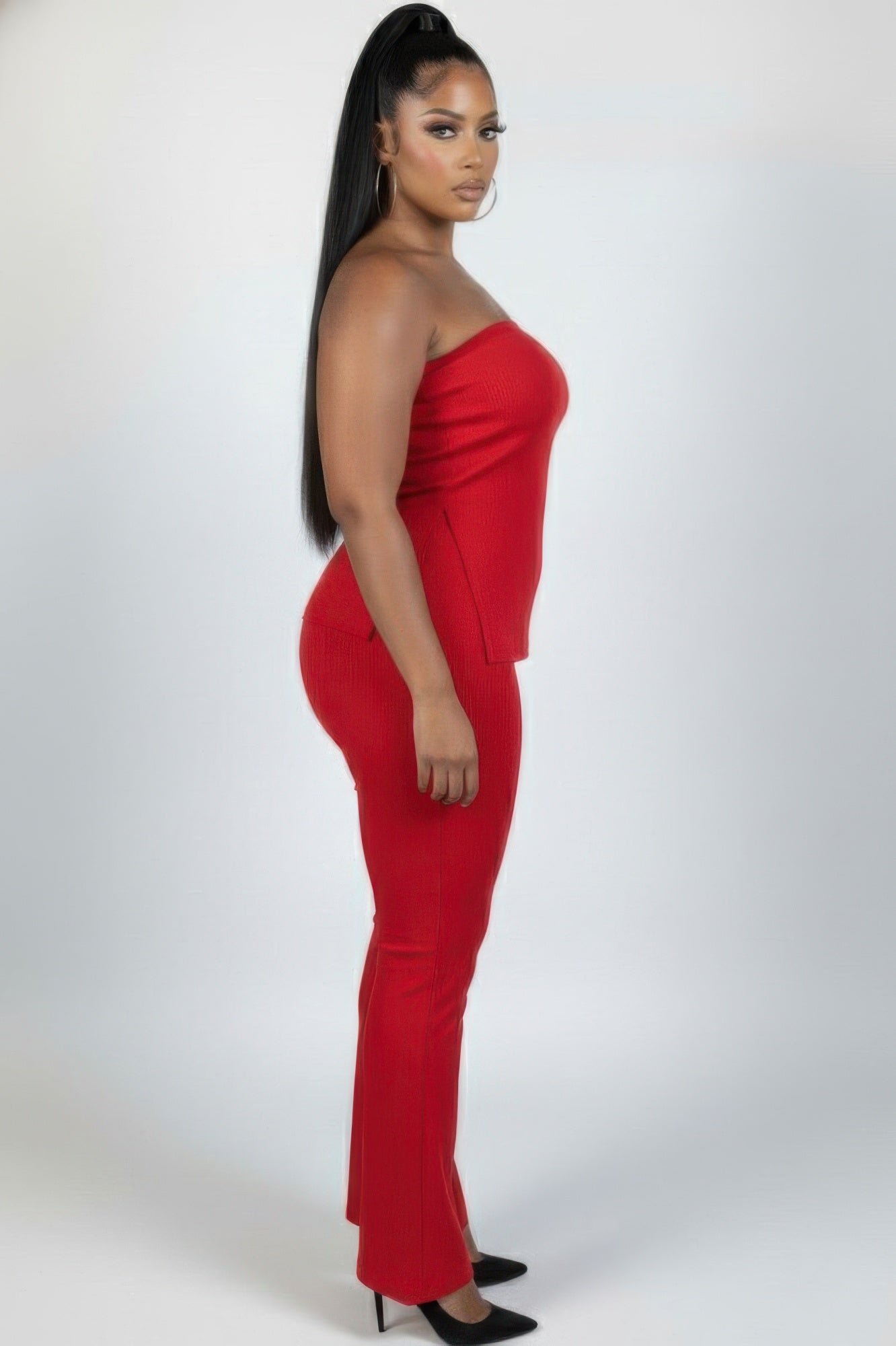 Plus size ribbed tube top and flare pants set in vibrant red, showcasing a confident and stylish look with side slit.