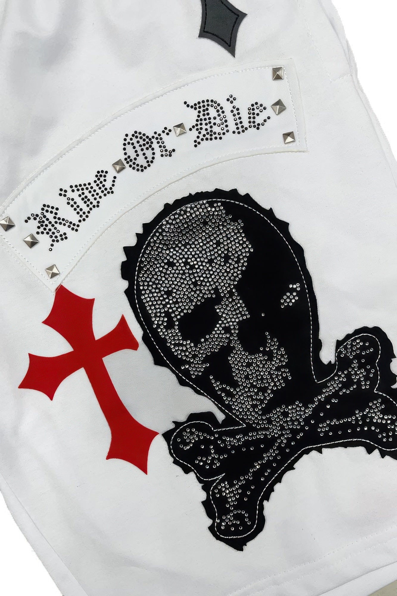 men's chrome cross graphic t-shirt and shorts set in White Red, close-up of skull graphic with red cross and studded “Mr. Die” detail
