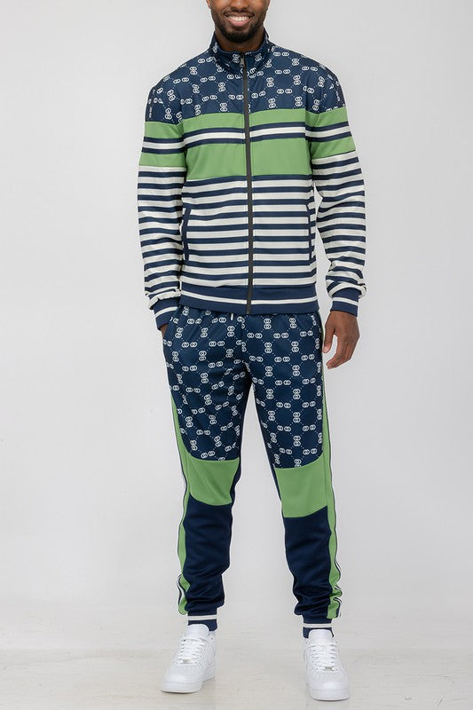 Man wearing a stylish Chain Link Track Suit featuring a long sleeve zip jacket and matching jogger pants.