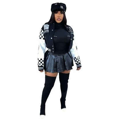 Fashionable woman in urban street style jacket with black skirt and accessories, showcasing bold streetwear.