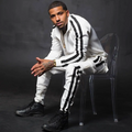 Men's striped jogger set featuring a zip-front track jacket and tapered jogger pants with contrast side stripes.