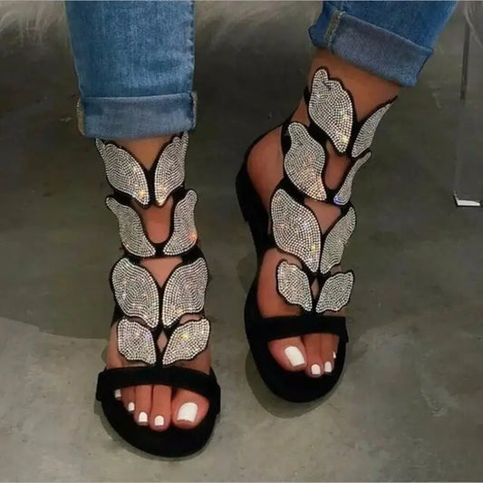Crystal Butterfly Ankle-Strap Gladiator Sandals in black with sparkling butterfly details on open-toe design.
