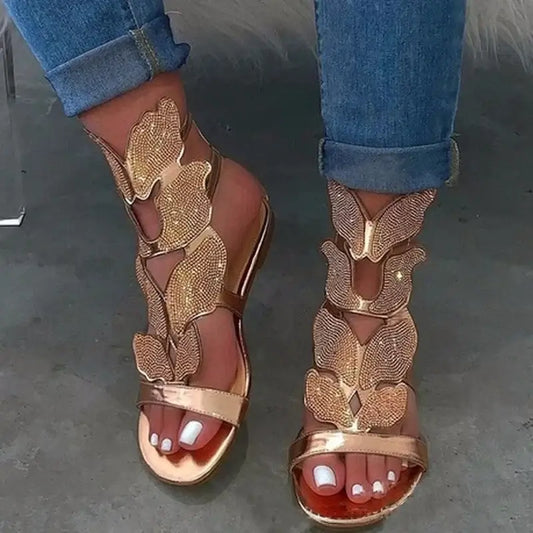 Crystal Butterfly Ankle-Strap Gladiator Sandals in gold with sparkling butterfly accents and open-toe design.