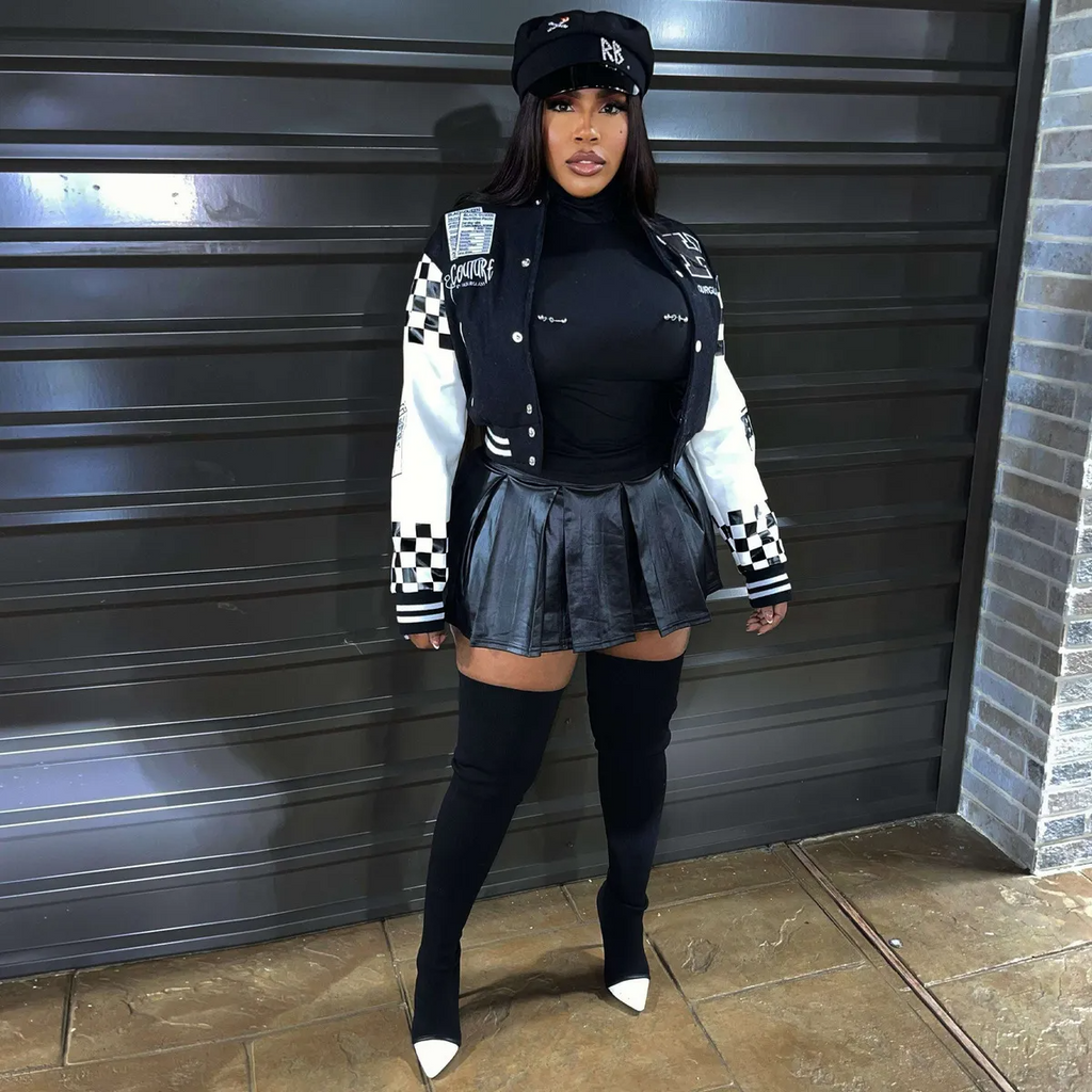 Urban street style jacket featuring a bold checkerboard design, paired with a stylish mini skirt, showcasing confidence.