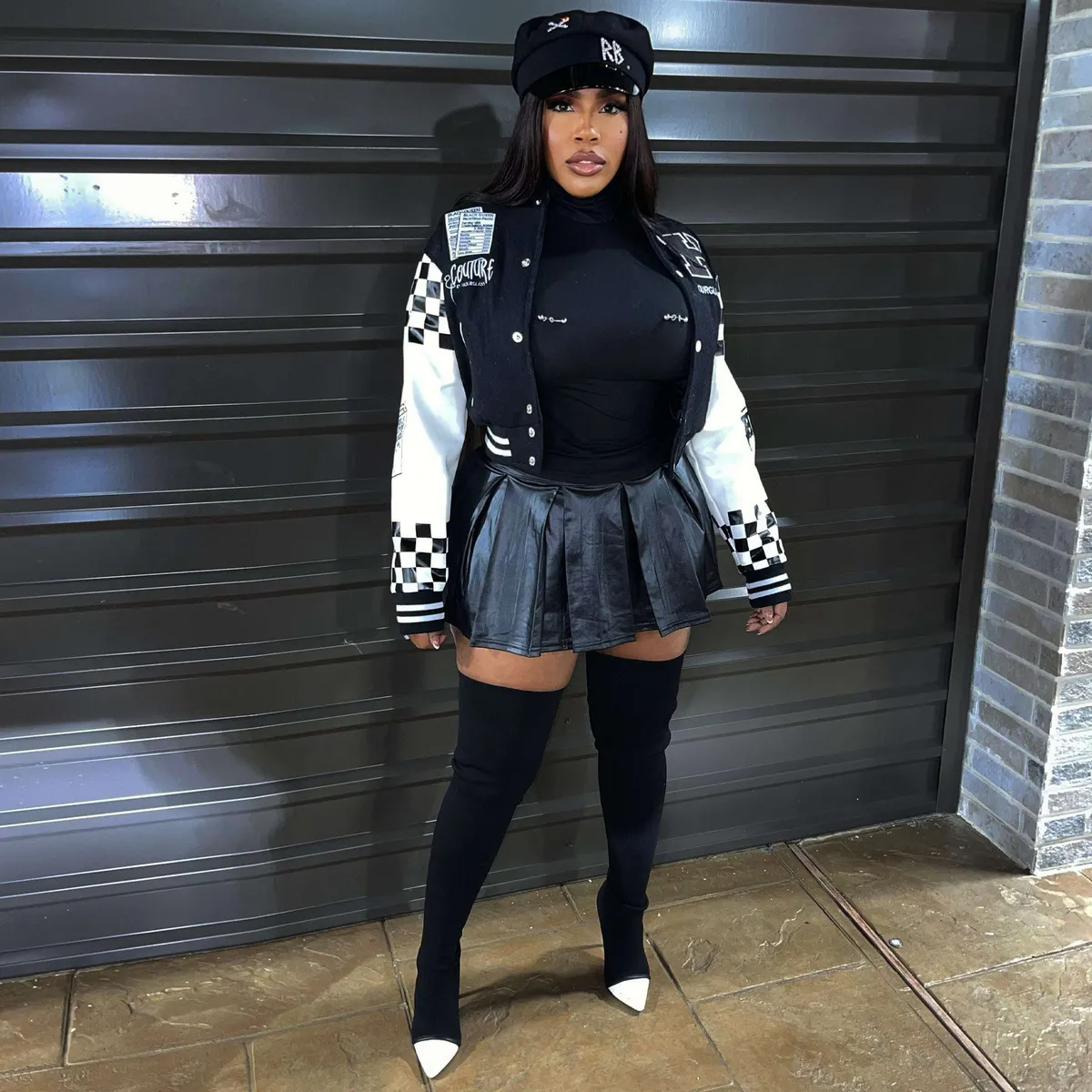 Urban street style jacket featuring a bold checkerboard design, paired with a stylish mini skirt, showcasing confidence.