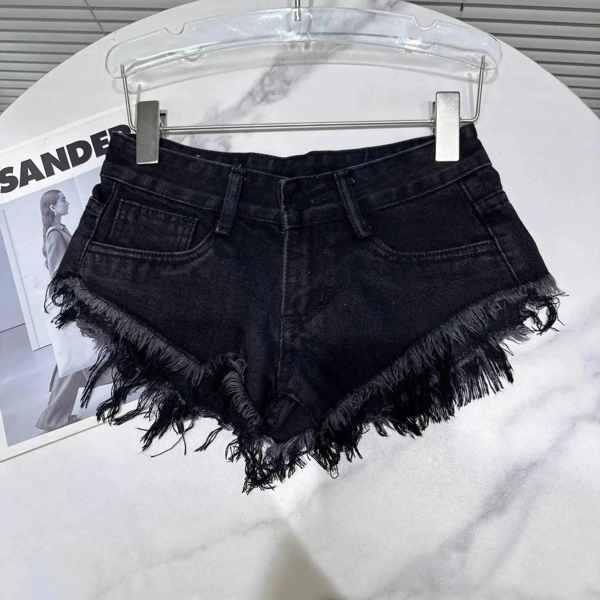 Distressed Raw-Hem Low-Rise Denim Shorts with frayed hem and low-rise fit, perfect for summer outfits.