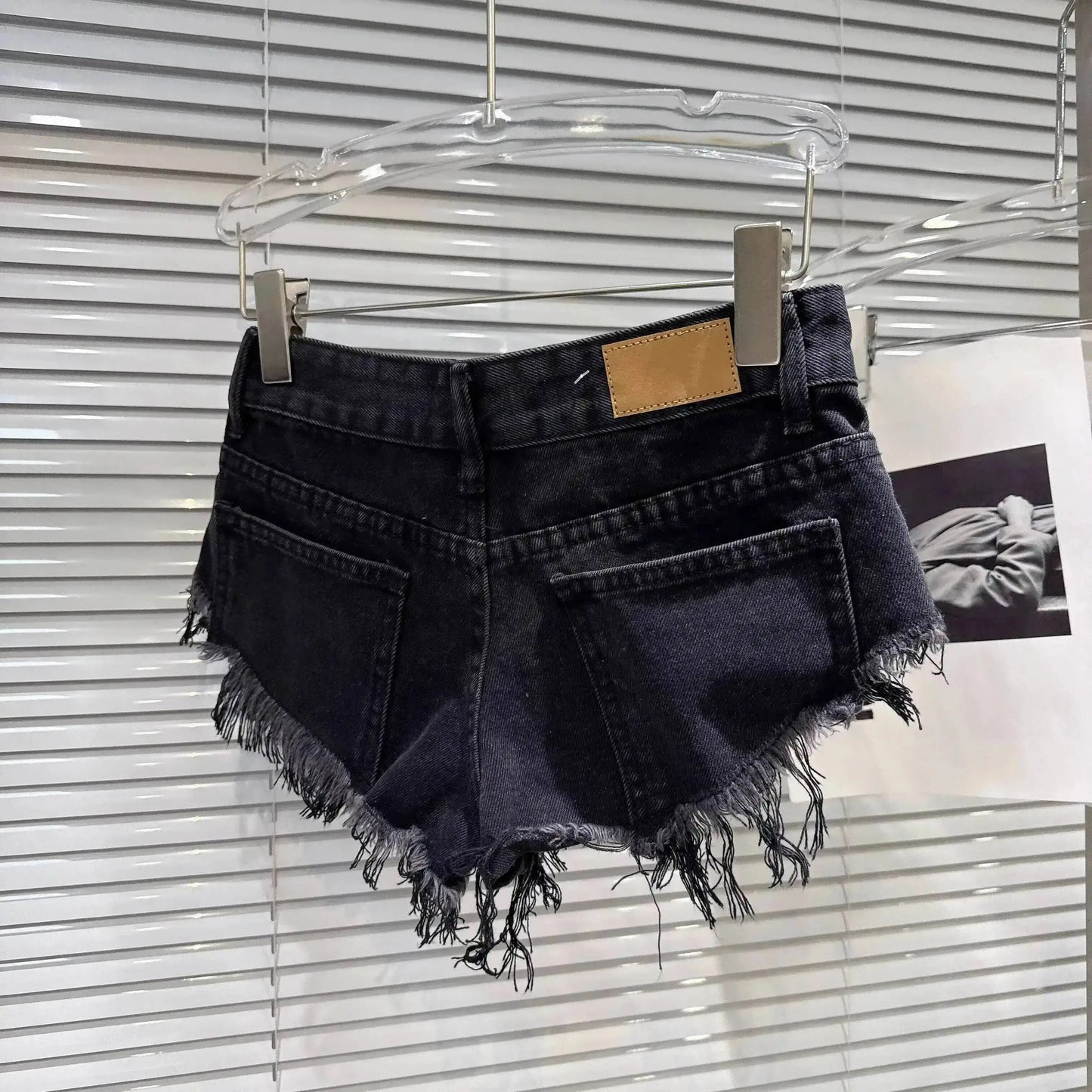 Distressed Raw-Hem Low-Rise Denim Shorts with frayed hem, fitted waist, and cutoff silhouette, perfect for summer outfits.