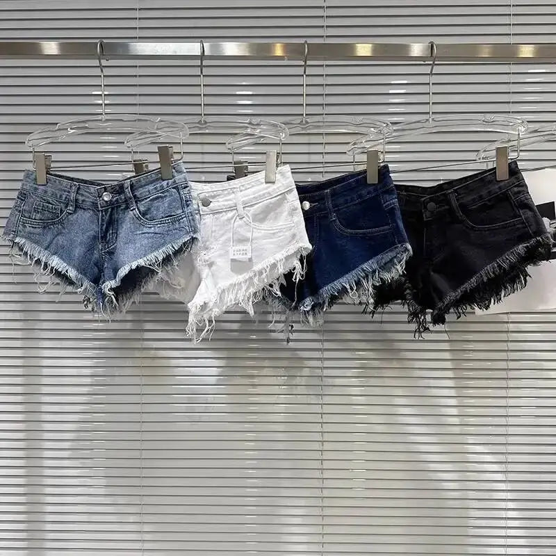 Distressed Raw-Hem Low-Rise Denim Shorts in four colors hanging on display.