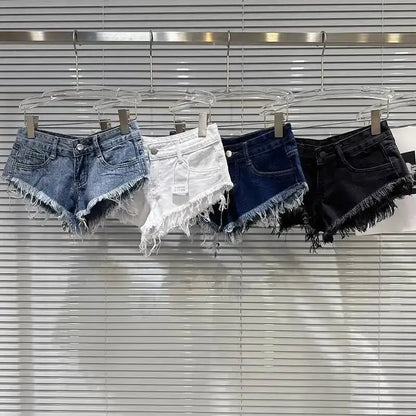 Distressed Raw-Hem Low-Rise Denim Shorts in four colors hanging on display.