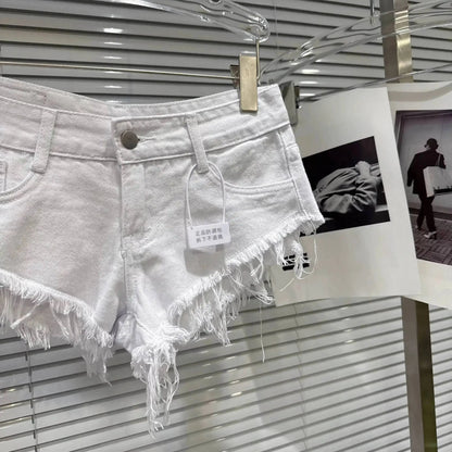 Distressed Raw-Hem Low-Rise Denim Shorts hanging on display with frayed hem and tag.
