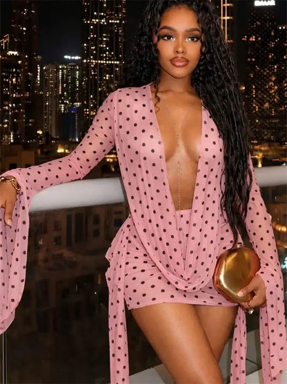 Draped Cowl Neck Printed Backless Mini Dress in pink with polka dots, featuring a plunging neckline and flowing batwing sleeves.
