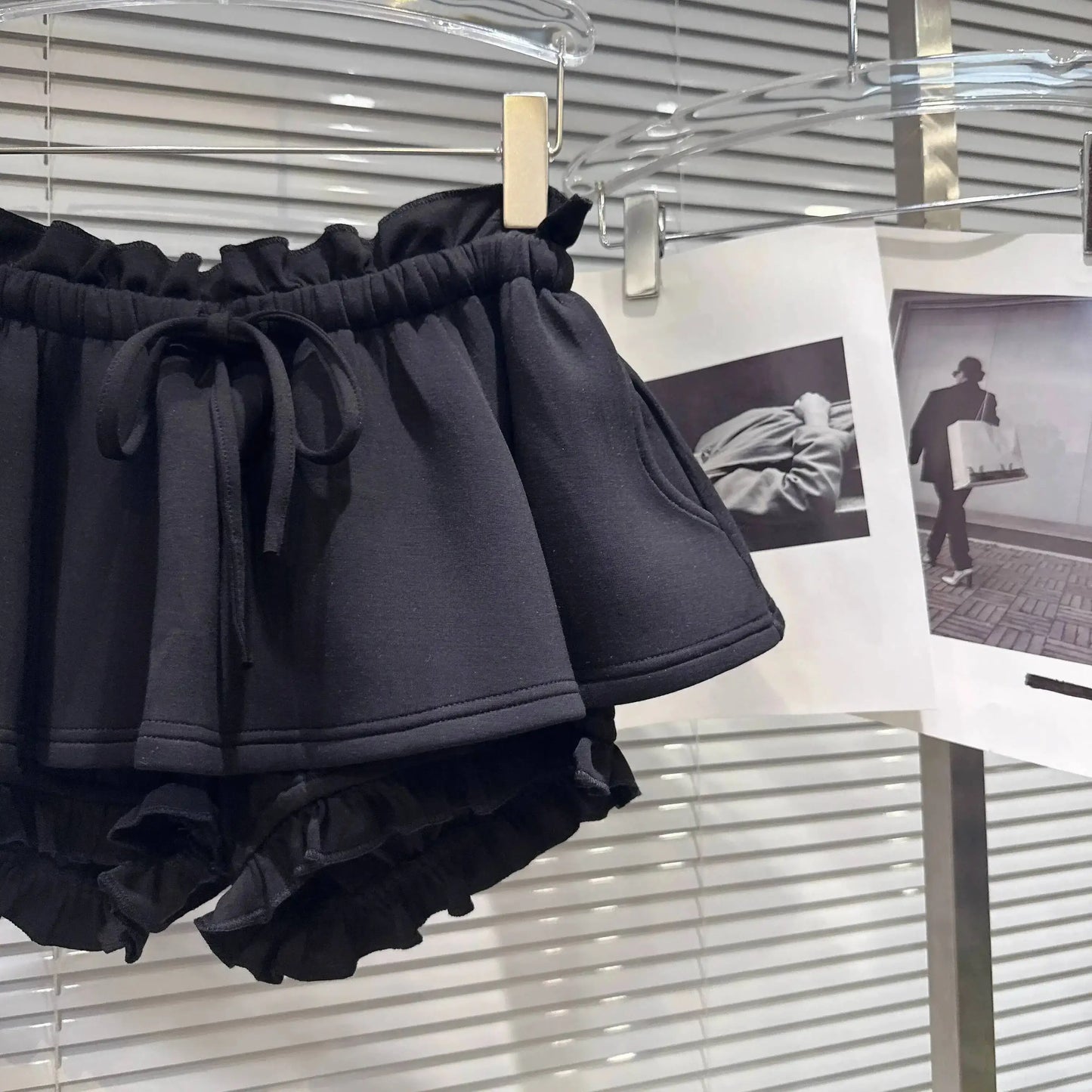 Layered Ruffle Drawstring Mini Skort hanging display with ruffled shorts underlayer.