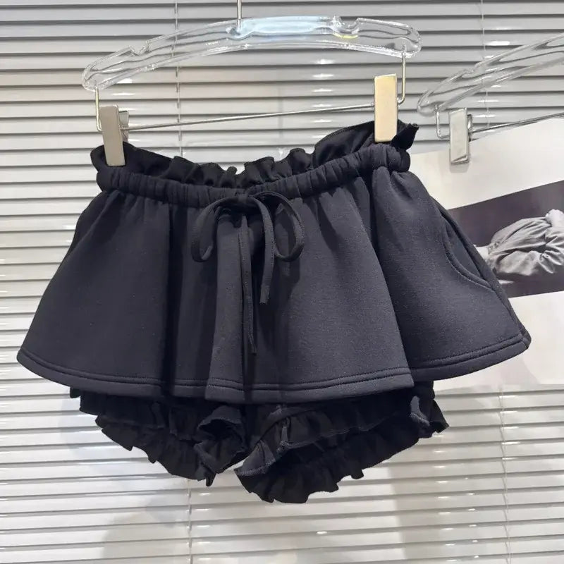 Layered Ruffle Drawstring Mini Skort in black with ruffled shorts underlayer and adjustable waistband.