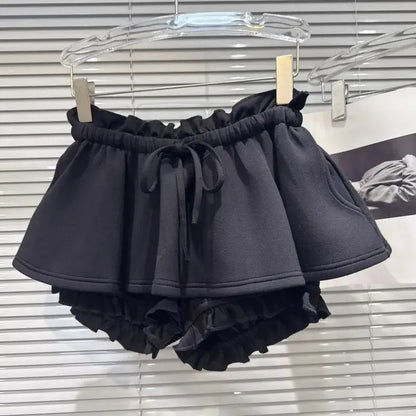 Layered Ruffle Drawstring Mini Skort in black with ruffled shorts underlayer and adjustable waistband.