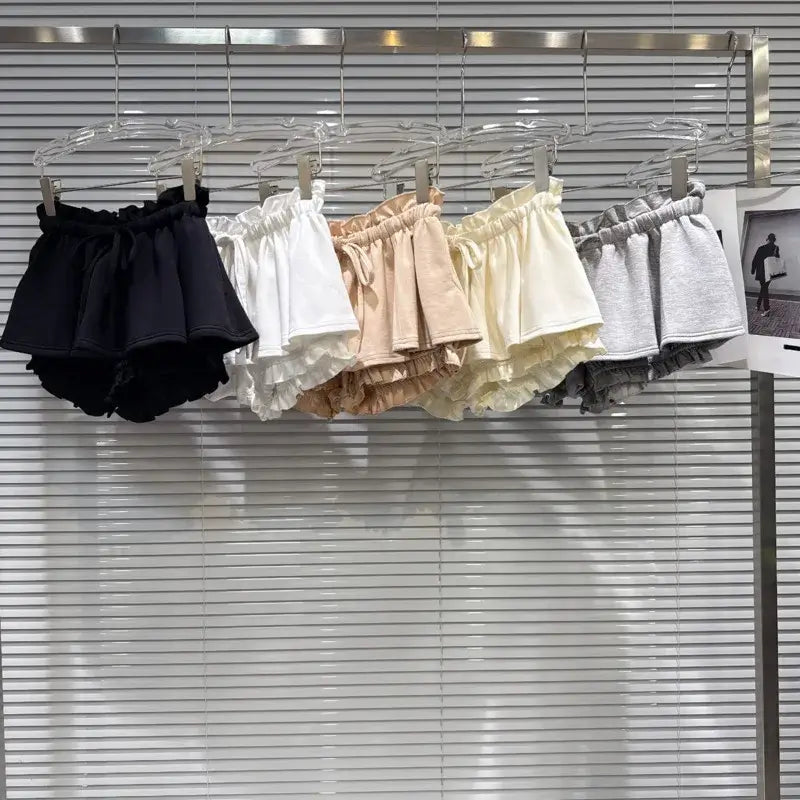 Layered Ruffle Drawstring Mini Skorts in various colors hanging on display.