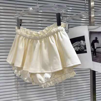 Layered Ruffle Drawstring Mini Skort displayed in soft cream color with layered ruffle details and elastic waistband.
