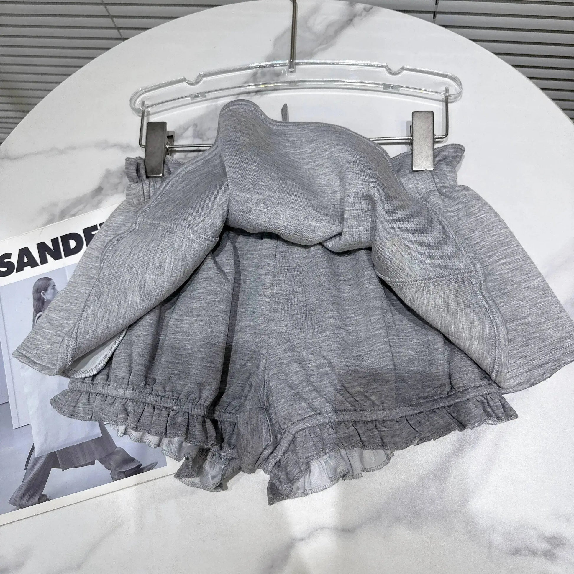 Layered Ruffle Drawstring Mini Skort in grey, showcasing ruffled layers and adjustable drawstring waistband.