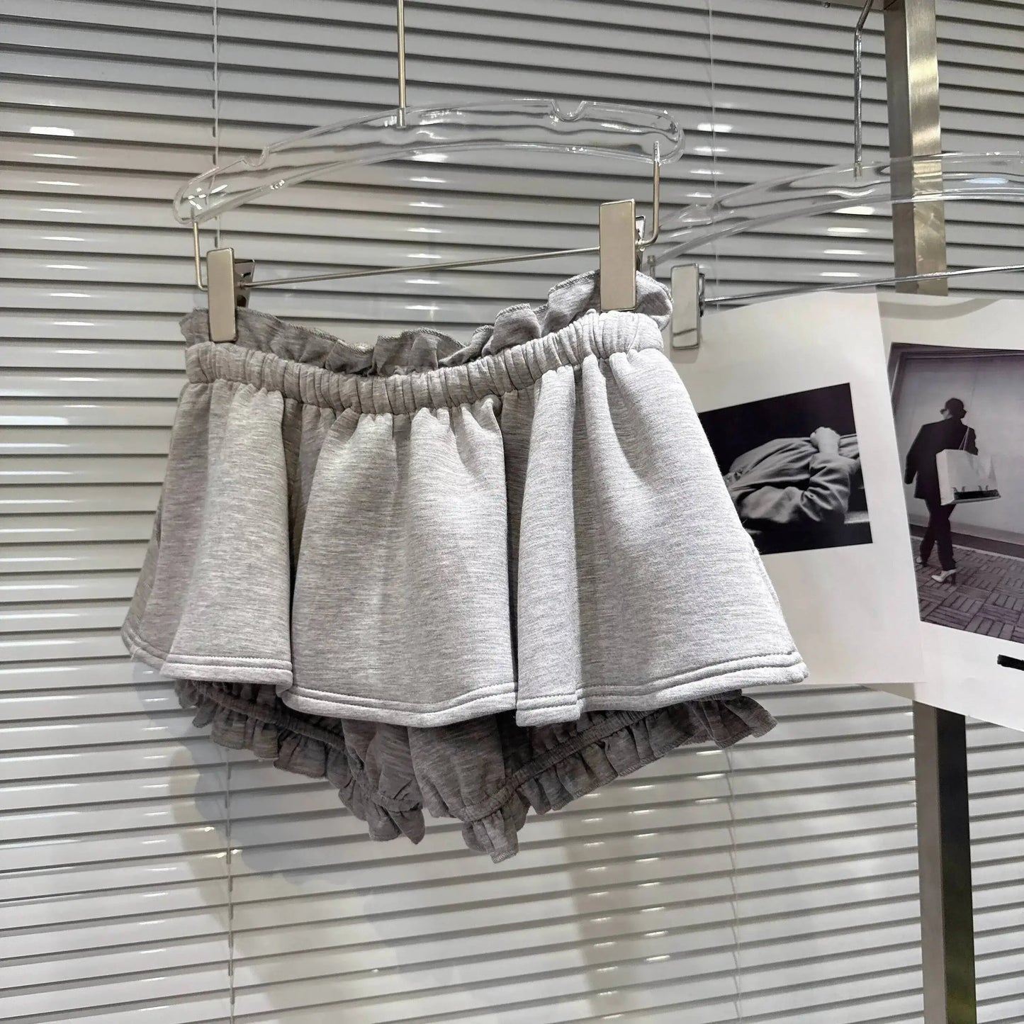 Layered Ruffle Drawstring Mini Skort displayed on a hanger, showcasing its ruffled design and elastic waistband.