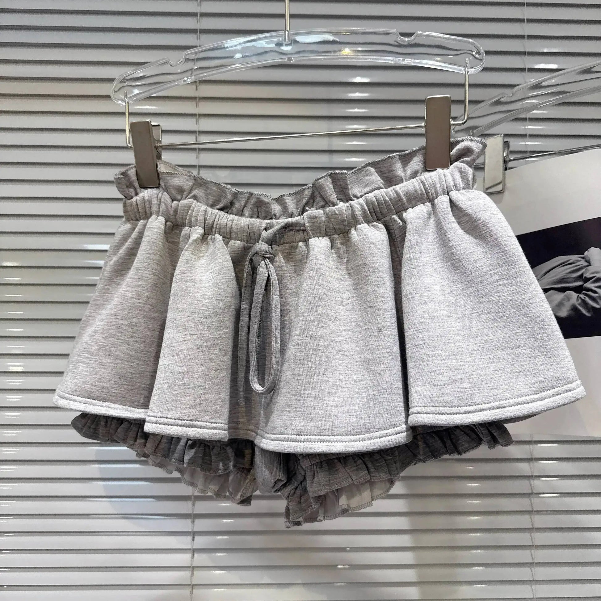 Layered Ruffle Drawstring Mini Skort showcasing a playful grey design with ruffled layers and an adjustable waistband.