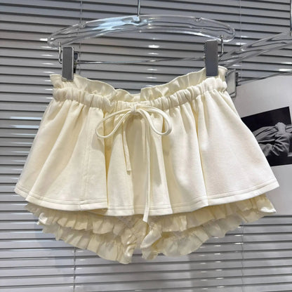 Layered Ruffle Drawstring Mini Skort in cream color with elastic waistband and ruffle details.