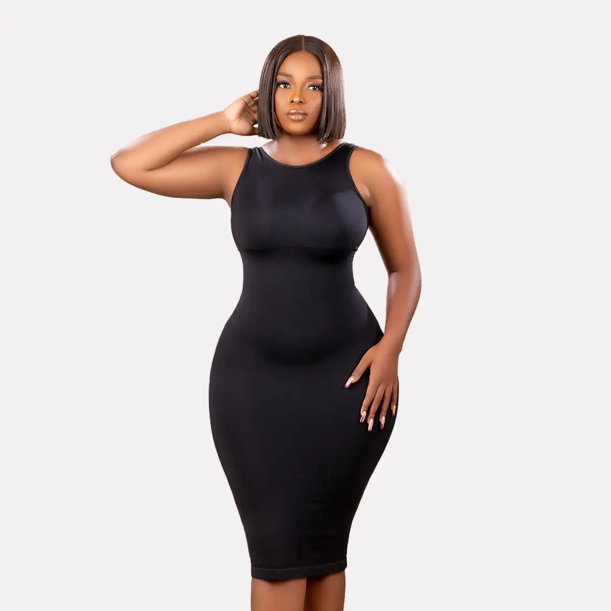 Model wearing a black tummy control bodycon dress with a seamless design and built-in shapewear.