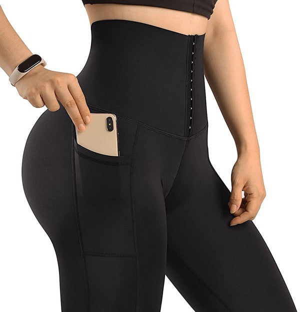 Model wearing Sculpt Mode high-waist shaping leggings with pockets, demonstrating the functional side pocket.