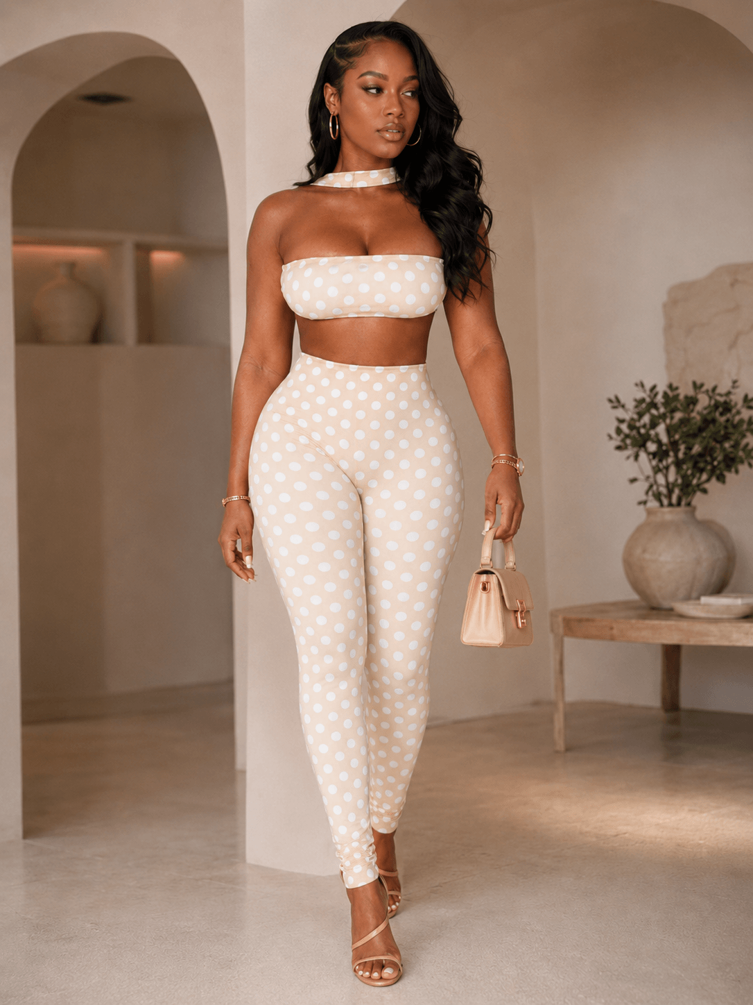 Model wearing retro polka dot crop top set featuring a bandeau top and high-waist leggings.